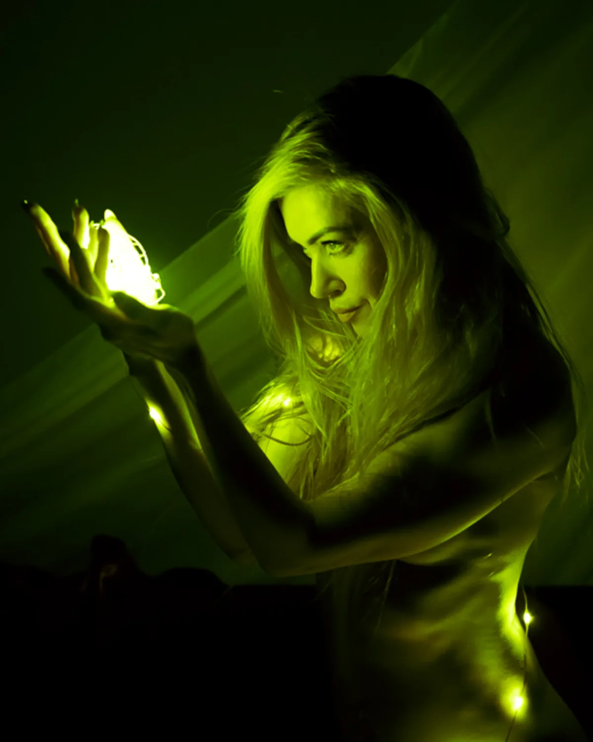 Nude White woman glowing with internal string lights in a dark room,
cupping her hands in an ethereal boudoir portrait