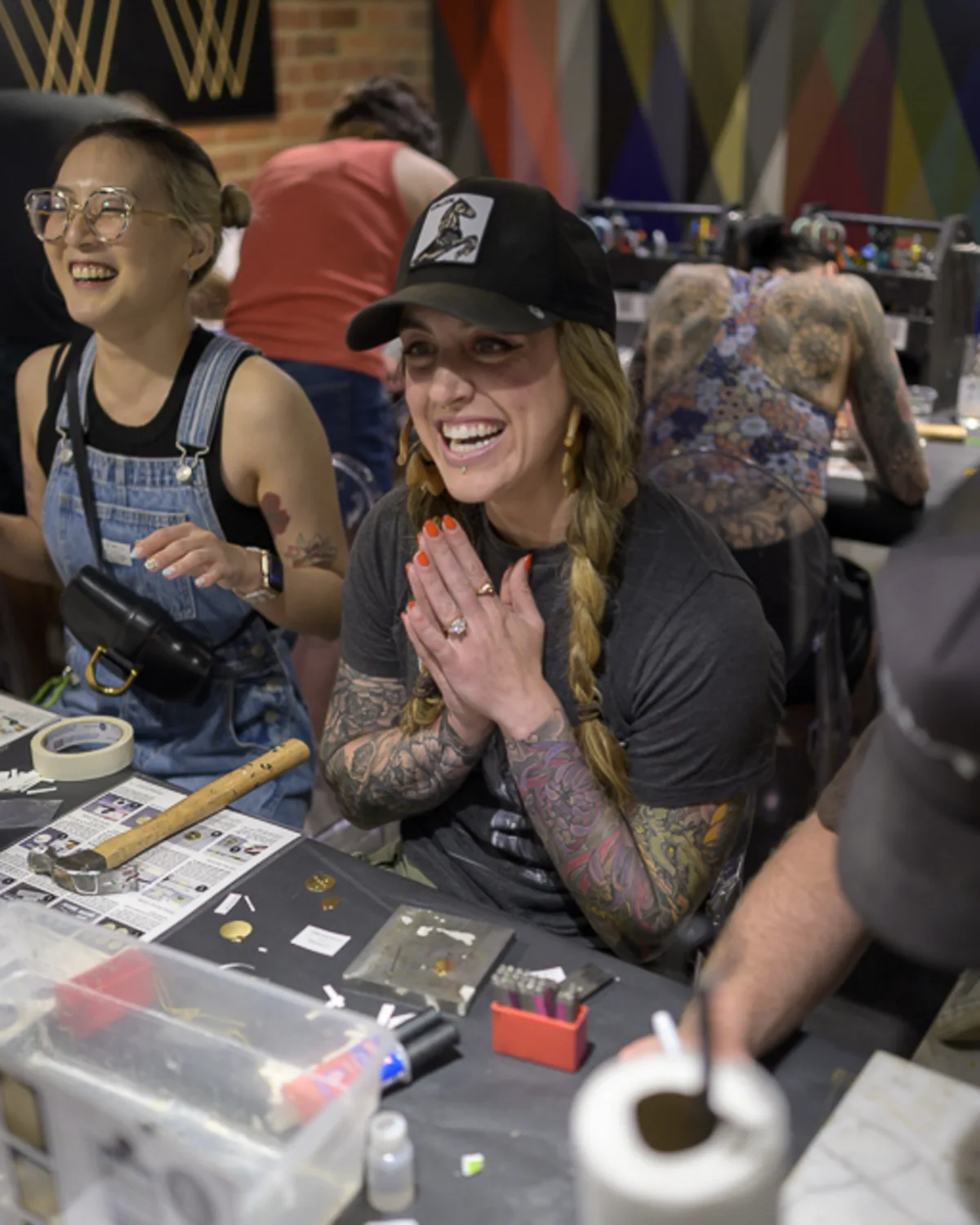 Coworkers laughing and making crafts during a corporate team-building
event at Upstairs Circus in Denver, captured with candid event photography