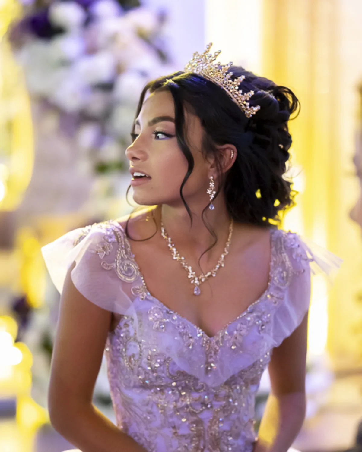 Teen girl in ornate lavender gown and tiara at her Quinceañera celebration
at Venus Event Center in Commerce City, CO, captured with elegant event photography